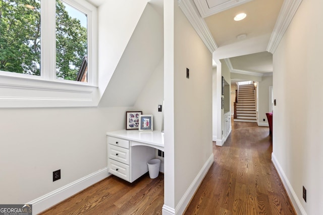 hallway with lofted ceiling, dark hardwood / wood-style floors, and ornamental molding