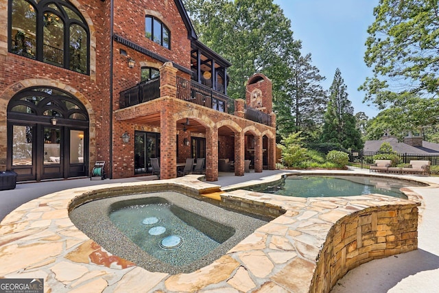 view of pool with an in ground hot tub, french doors, and a patio area