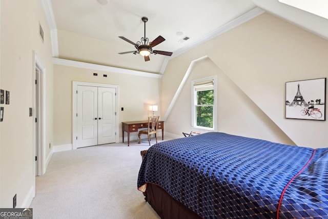 bedroom featuring lofted ceiling, crown molding, ceiling fan, light colored carpet, and a closet