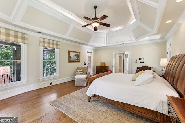 bedroom featuring ceiling fan, coffered ceiling, hardwood / wood-style flooring, and ornamental molding