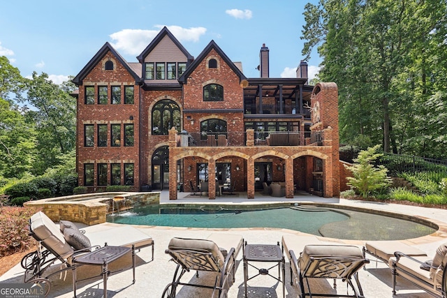 view of pool with an in ground hot tub and a patio