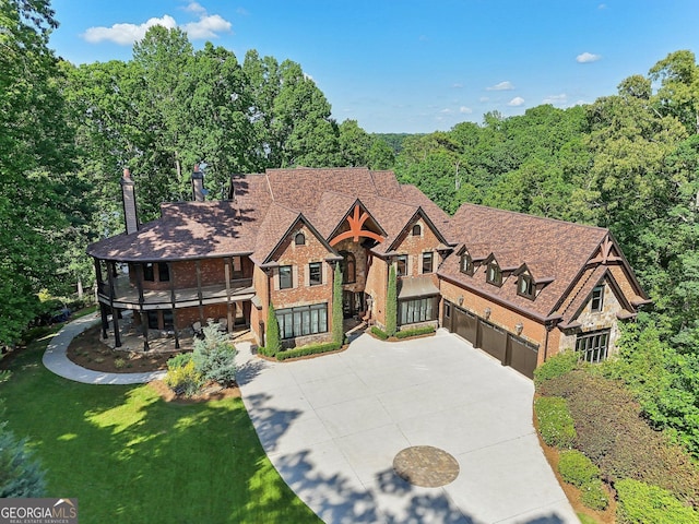 view of front of house with a balcony and a front lawn