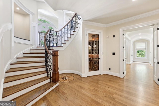 entrance foyer featuring light hardwood / wood-style floors and crown molding