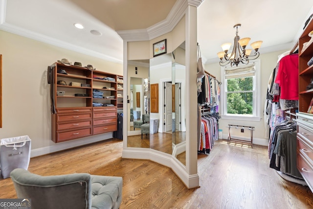 walk in closet featuring hardwood / wood-style floors and an inviting chandelier