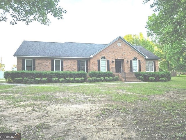 ranch-style home with a front lawn