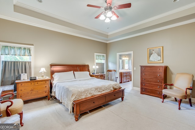 bedroom with light colored carpet, ensuite bath, ceiling fan, and crown molding