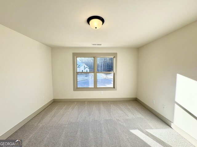 empty room featuring light colored carpet