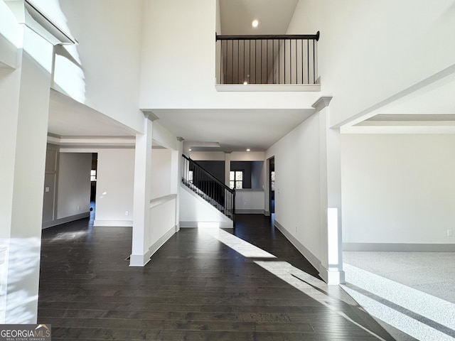 entrance foyer with an inviting chandelier, a wealth of natural light, and decorative columns