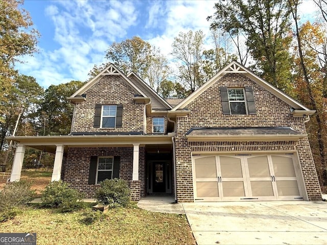 view of front of property featuring covered porch and a garage