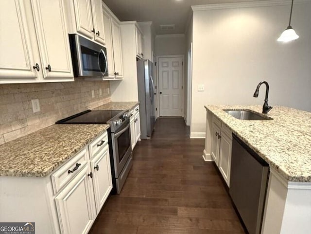 kitchen with white cabinets, hanging light fixtures, light stone countertops, sink, and stainless steel appliances