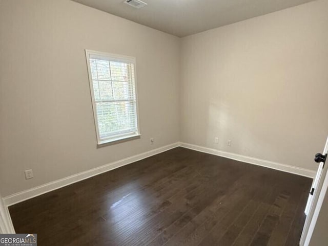 empty room with dark hardwood / wood-style floors