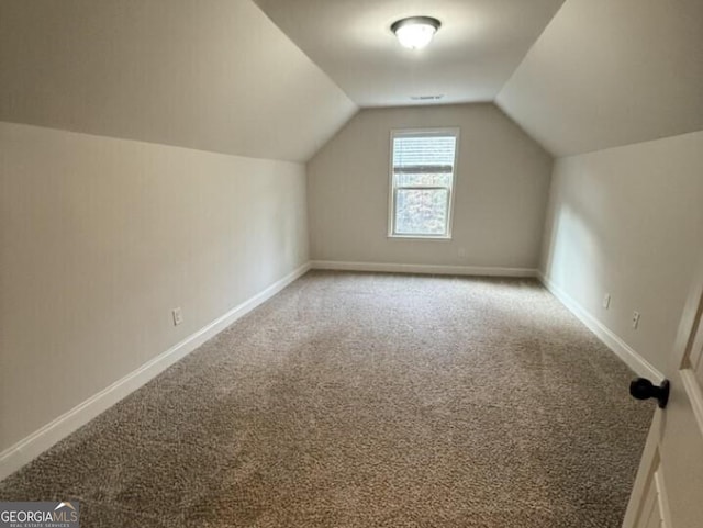 bonus room featuring carpet and vaulted ceiling