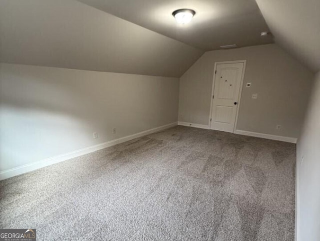 additional living space with carpet and lofted ceiling