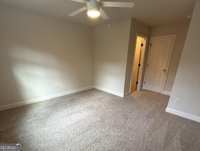 empty room with carpet flooring and ceiling fan