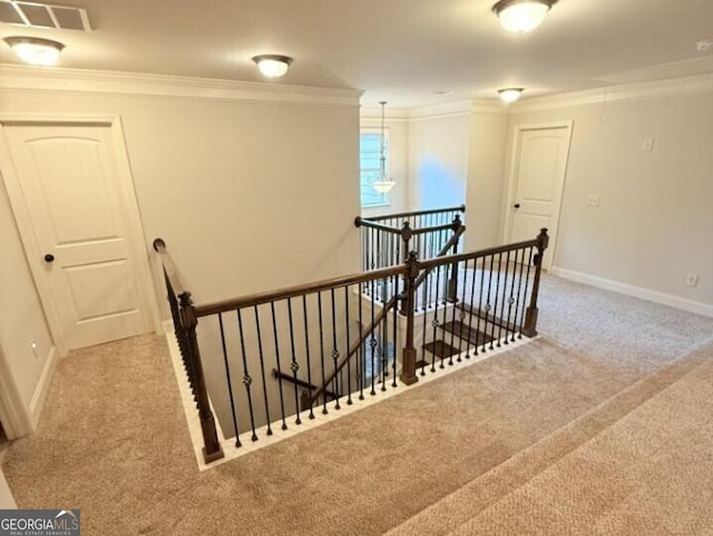 stairway with crown molding and carpet flooring