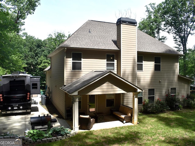 rear view of property with a patio area, a yard, and central AC unit