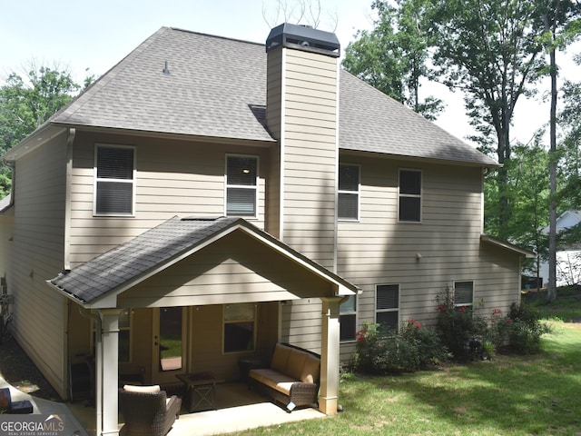 rear view of house featuring a yard