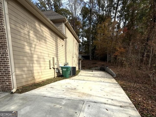 view of home's exterior with central air condition unit and a patio