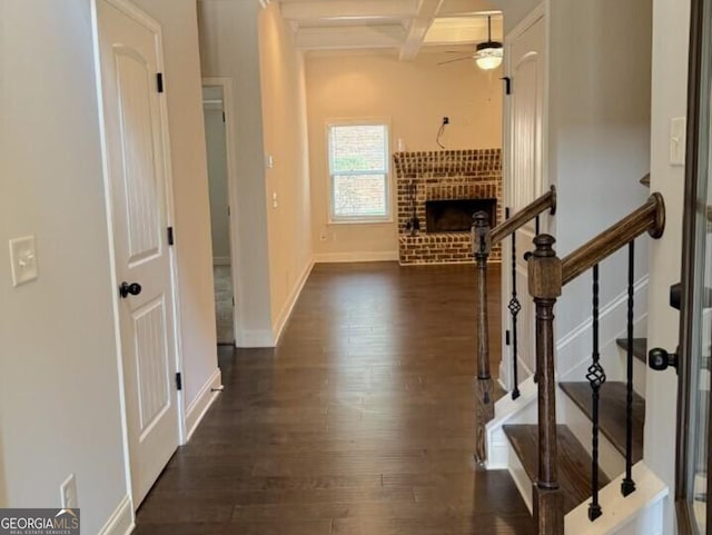 hallway featuring beam ceiling, coffered ceiling, and dark hardwood / wood-style flooring