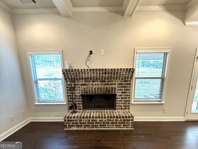 unfurnished living room with beam ceiling, a wealth of natural light, a fireplace, and dark hardwood / wood-style flooring