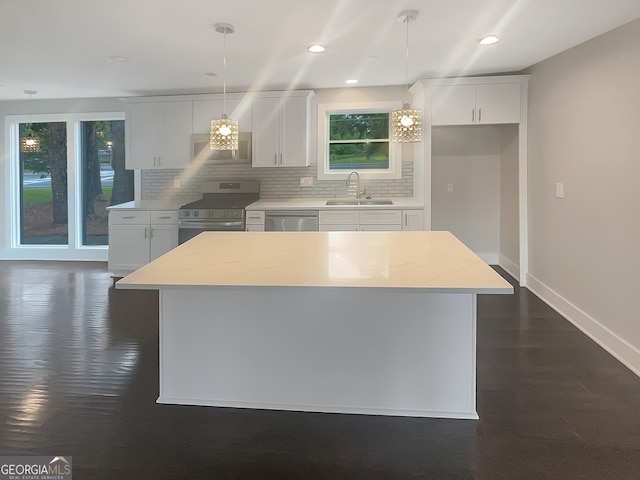 kitchen with dark hardwood / wood-style floors, backsplash, white cabinetry, appliances with stainless steel finishes, and sink