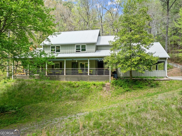 back of property featuring a yard and a porch