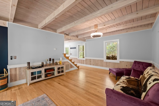 living room with beamed ceiling, light wood-type flooring, and wood ceiling