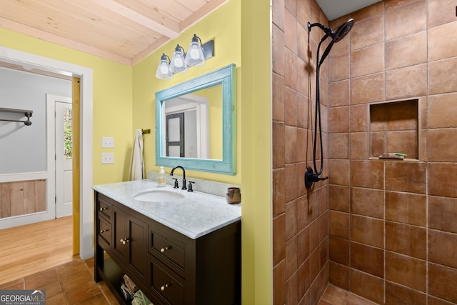 bathroom with wooden ceiling, tile flooring, vanity, and beam ceiling