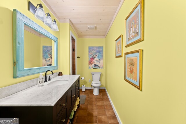 bathroom with tile flooring, vanity, toilet, and wood ceiling