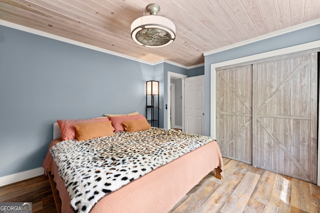 bedroom featuring wooden ceiling, hardwood / wood-style floors, and ornamental molding