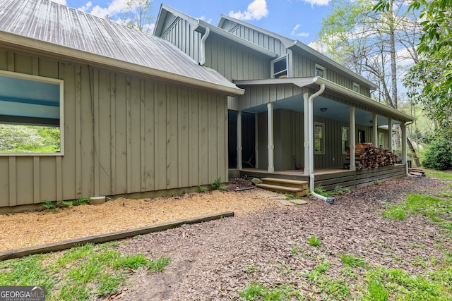 view of side of property featuring covered porch