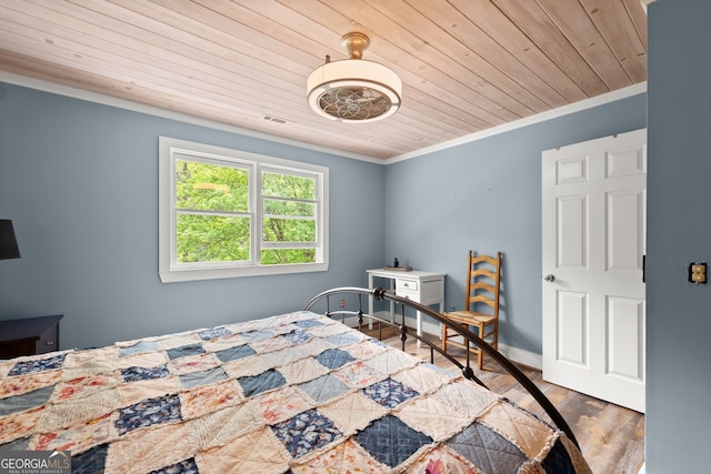 bedroom with wooden ceiling, ornamental molding, and hardwood / wood-style flooring