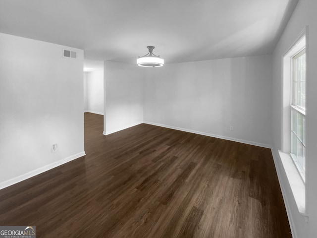 spare room featuring dark hardwood / wood-style floors