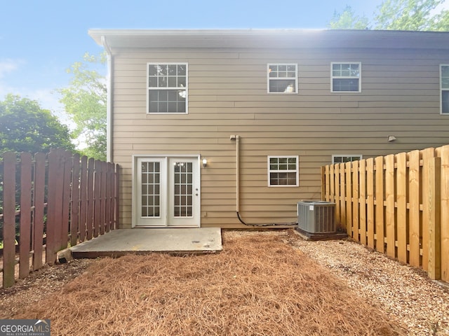 rear view of property with a patio and central air condition unit