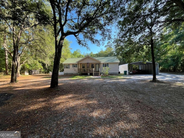 ranch-style home with a porch and a carport