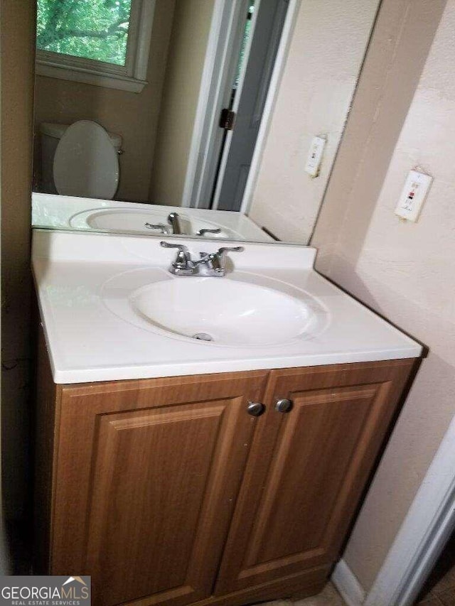 bathroom with oversized vanity and toilet