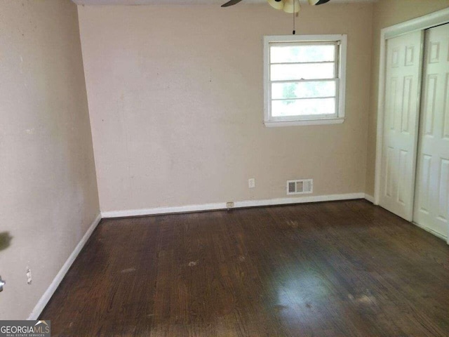 interior space with ceiling fan and dark hardwood / wood-style floors