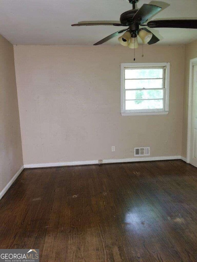 unfurnished room with ceiling fan and dark hardwood / wood-style flooring