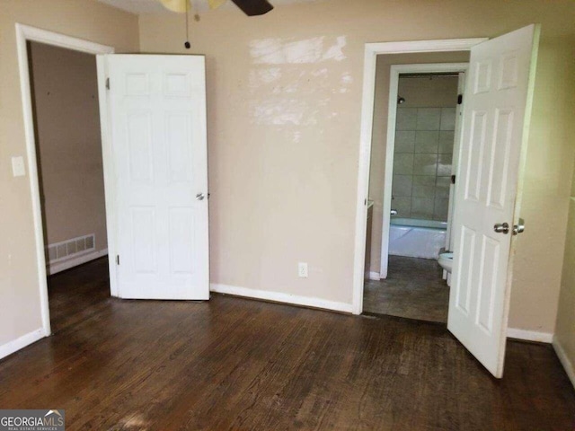 unfurnished bedroom featuring dark hardwood / wood-style flooring