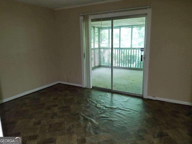 tiled spare room with crown molding