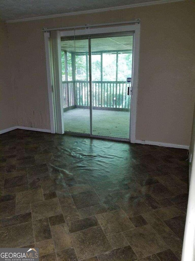 unfurnished room with crown molding and dark tile floors