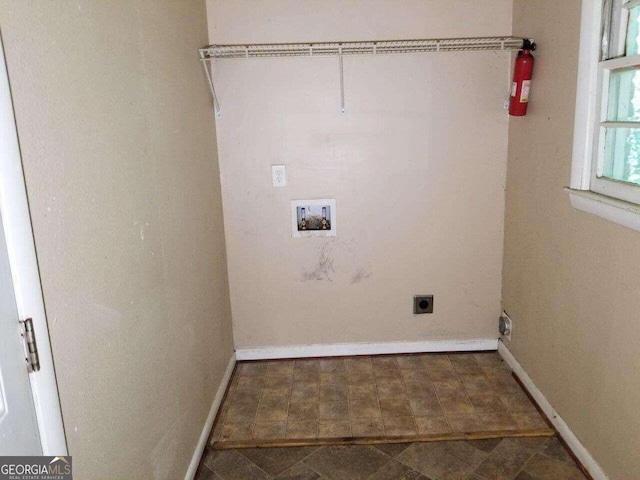 clothes washing area with washer hookup, hookup for an electric dryer, and dark tile floors