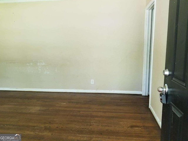 spare room featuring dark hardwood / wood-style floors