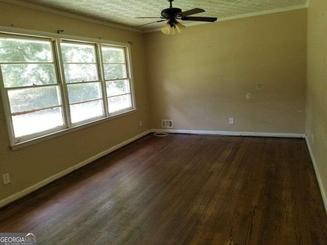 spare room featuring dark hardwood / wood-style floors, ceiling fan, and a textured ceiling