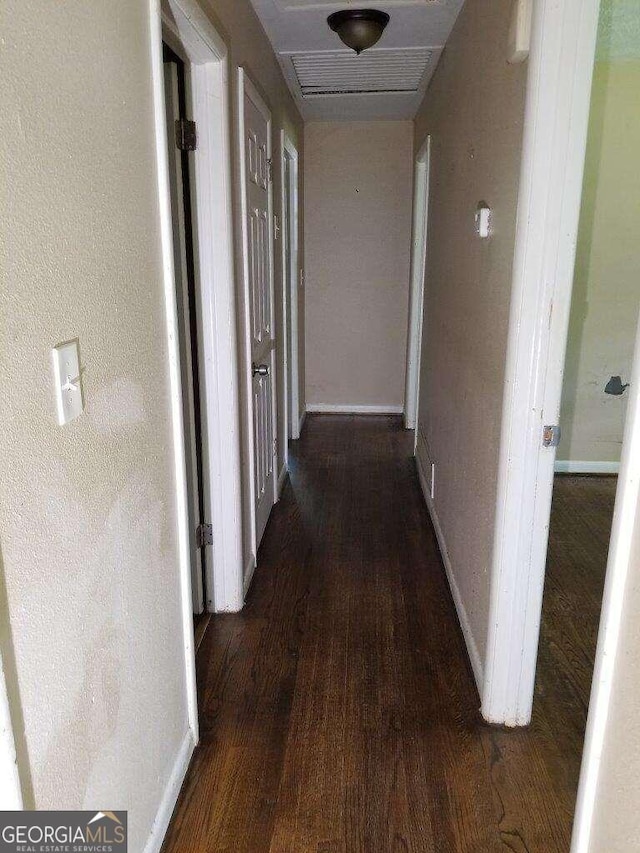 hallway with dark hardwood / wood-style floors