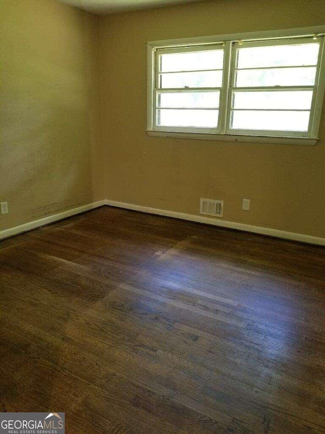 empty room featuring dark hardwood / wood-style floors