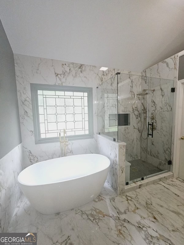 bathroom featuring plus walk in shower, tile walls, and vaulted ceiling