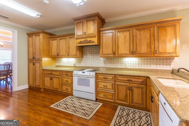 kitchen with light stone counters, sink, white appliances, and dark hardwood / wood-style floors