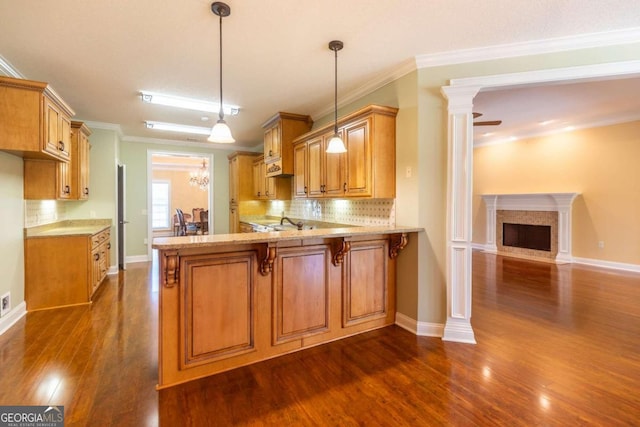 kitchen with tasteful backsplash, pendant lighting, and dark wood-type flooring