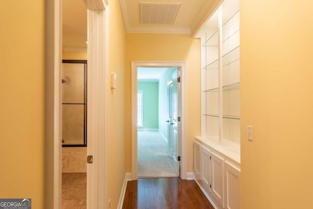 hall featuring crown molding and dark tile flooring